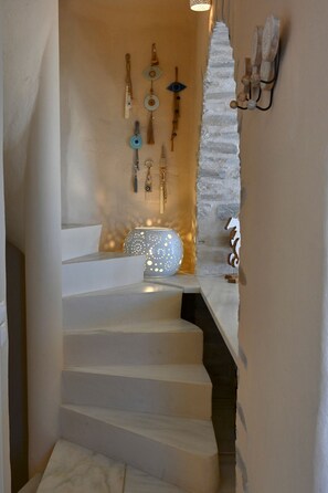 Eine Treppe mit weißer Wand und einer hängenden Leuchte.