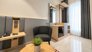 A modern hotel room with a desk, chair, and a potted plant. - Hotel Kyzen - Shamshabad Airport (Hyderabad)