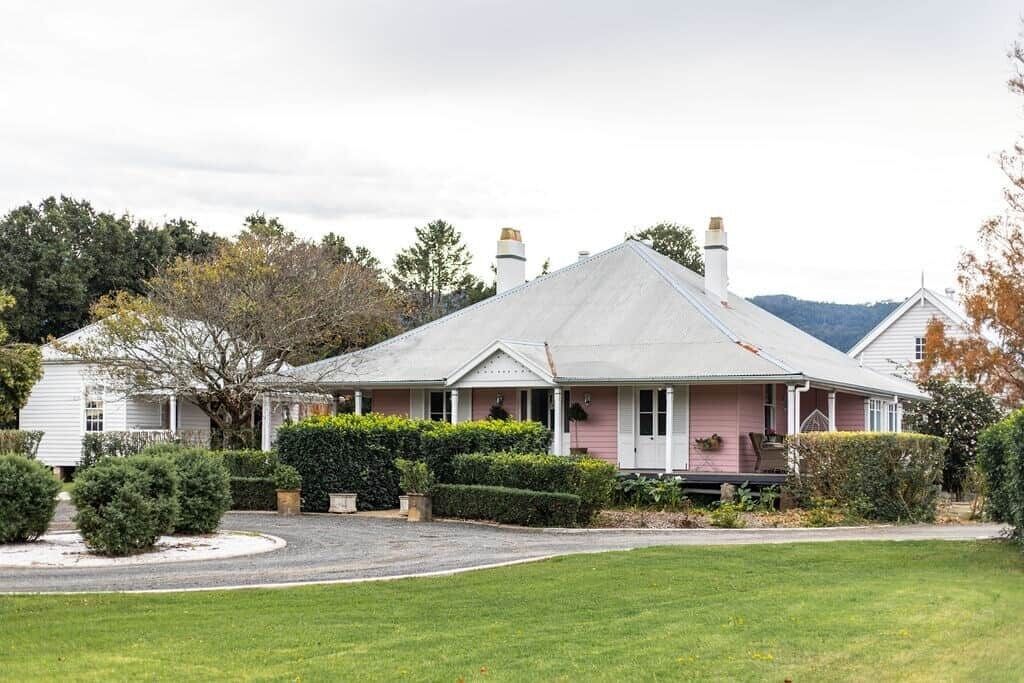 A single-story house with a gabled roof, a front porch, and a well-maintained lawn.