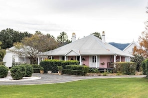 A single-story house with a gabled roof, a front porch, and a well-maintained lawn.