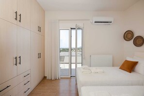 A bedroom with a bed, a wardrobe, a radiator, and a view through a door.