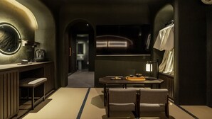 A modern interior with a seating area, a small table with a tray, and a television. - Cave Ryokan Hotel by Anook Seoul Jongno (Seoul)