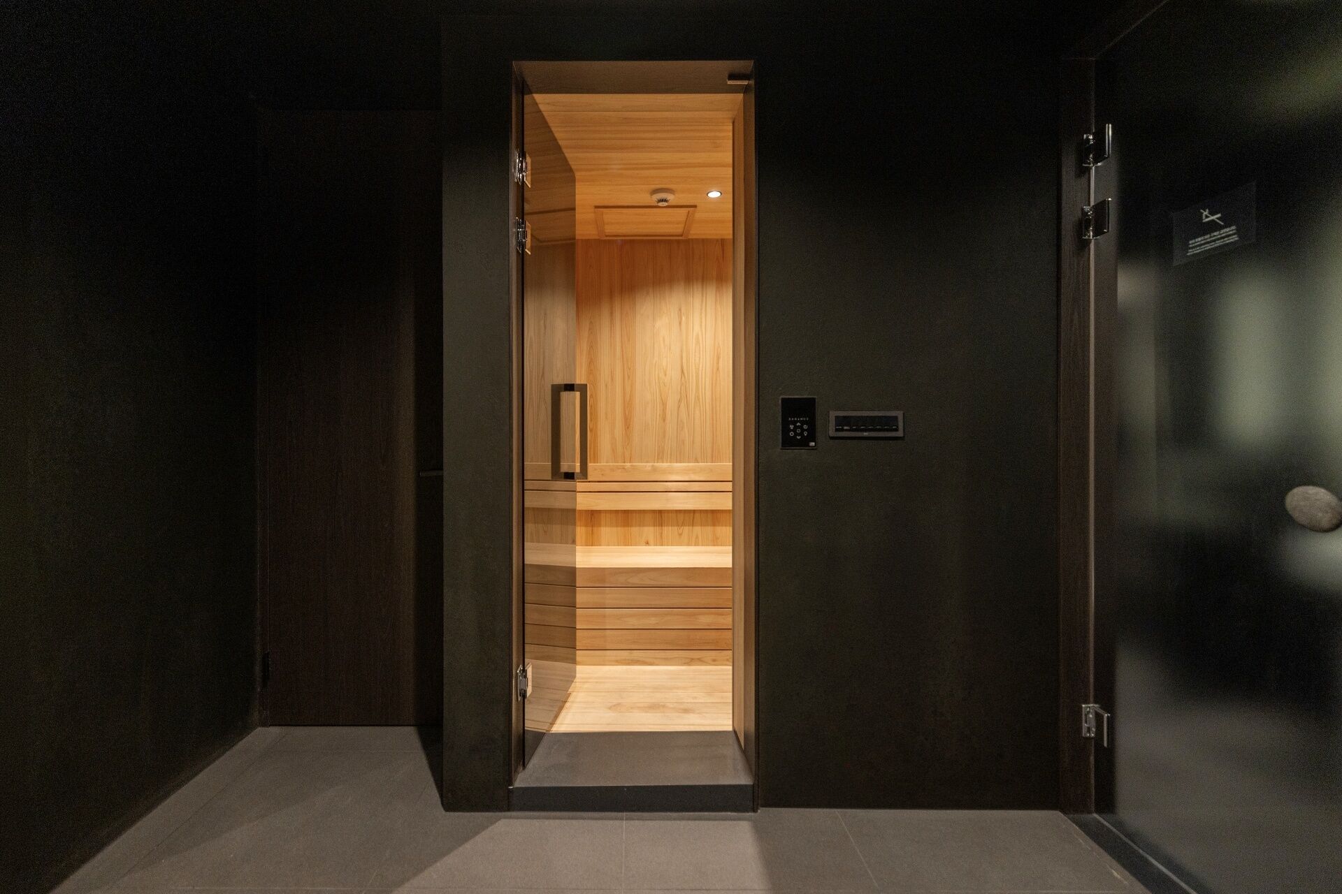 A modern elevator with a wooden interior and a control panel.