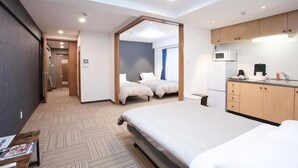 A hotel room with a large bed, a kitchenette, a bathroom, and a view of the hallway. - SHINKA HOTEL (Sapporo)
