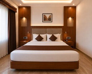 A modern hotel room with a large bed, wooden headboard, and two bedside tables with lamps.