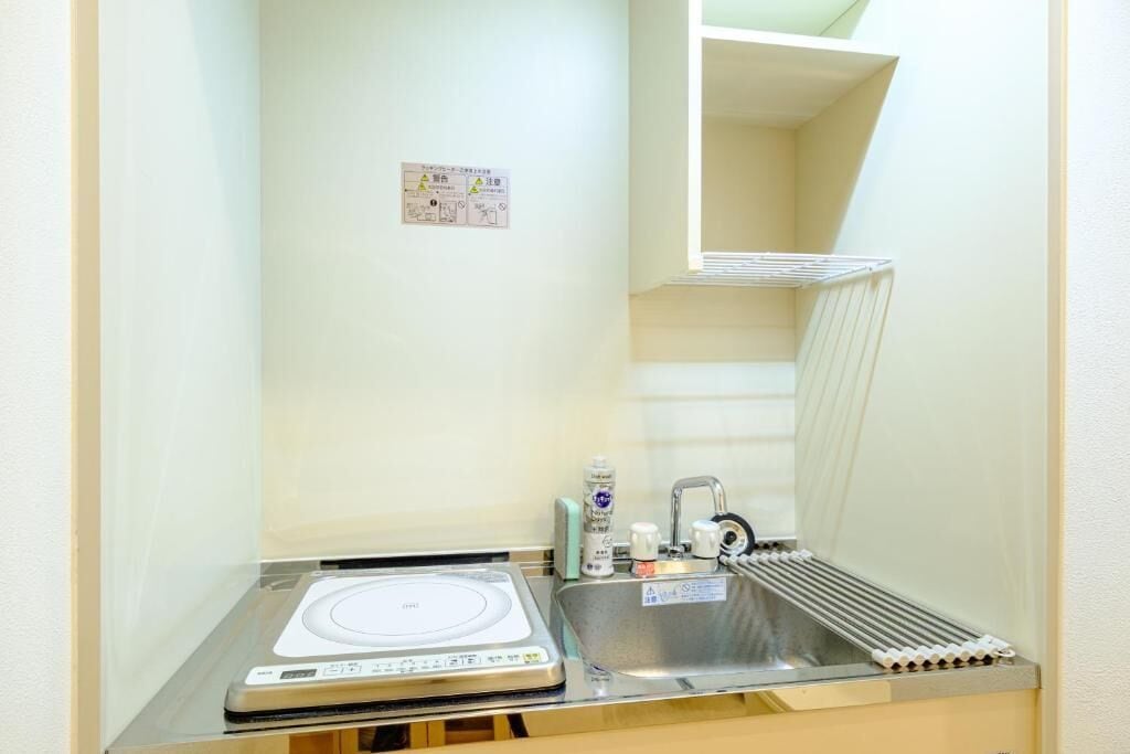 A small bathroom with a built-in scale, a sink, and a mirror.