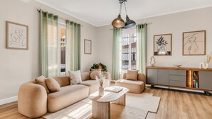 A modern living room with a sectional sofa, a coffee table, and a minimalist sideboard. - "La Grande Terrasse" Apartment with 40m2 Private Terrace, Wi-Fi, and Air Conditioning (Cannes)
