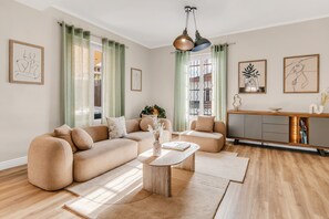A modern living room with a sectional sofa, a coffee table, and a minimalist sideboard. - "La Grande Terrasse" Apartment with 40m2 Private Terrace, Wi-Fi, and Air Conditioning (Cannes)