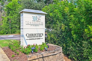 Schild für Christie's International Real Estate Emerald Coast, das ein Immobilienbüro kennzeichnet.