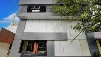 A modern building with a sign that reads 'Collection' and a company-serviced logo.