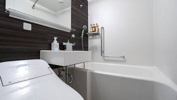A modern bathroom with a white sink, mirror, and bathtub.