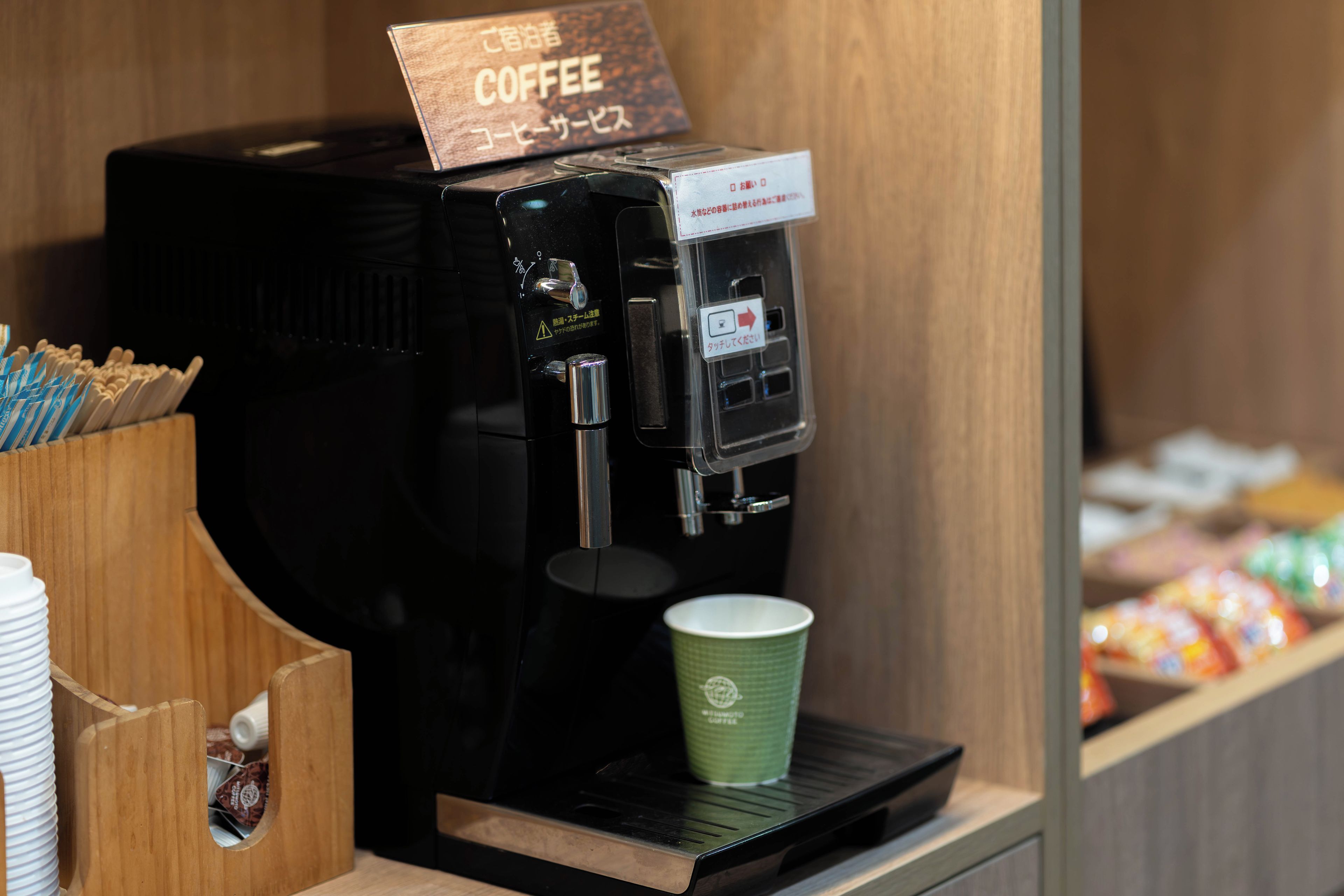 A coffee machine with a cup of coffee on the counter.