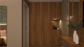 A modern interior with a wooden panel wall, a small shelf with a coffee maker, and a plant on a wooden console. - Feel Sintra (Sintra)