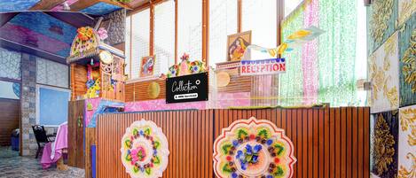 A reception desk with a sign that reads 'RECEPTION' and 'Collection'.