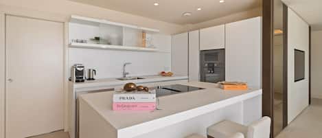 A modern kitchen with a central island, built-in appliances, and a minimalist design.