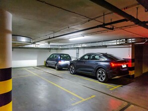 A parking garage with two cars parked in adjacent spaces. - House in Saint-pabu Near Stunning Beaches (Warsaw)