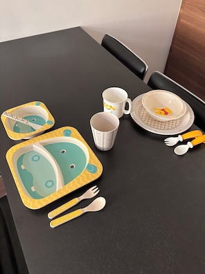 A dining table with a set of plates, bowls, cups, and cutlery. - The Basket Weaving Cocoon (Dijon)