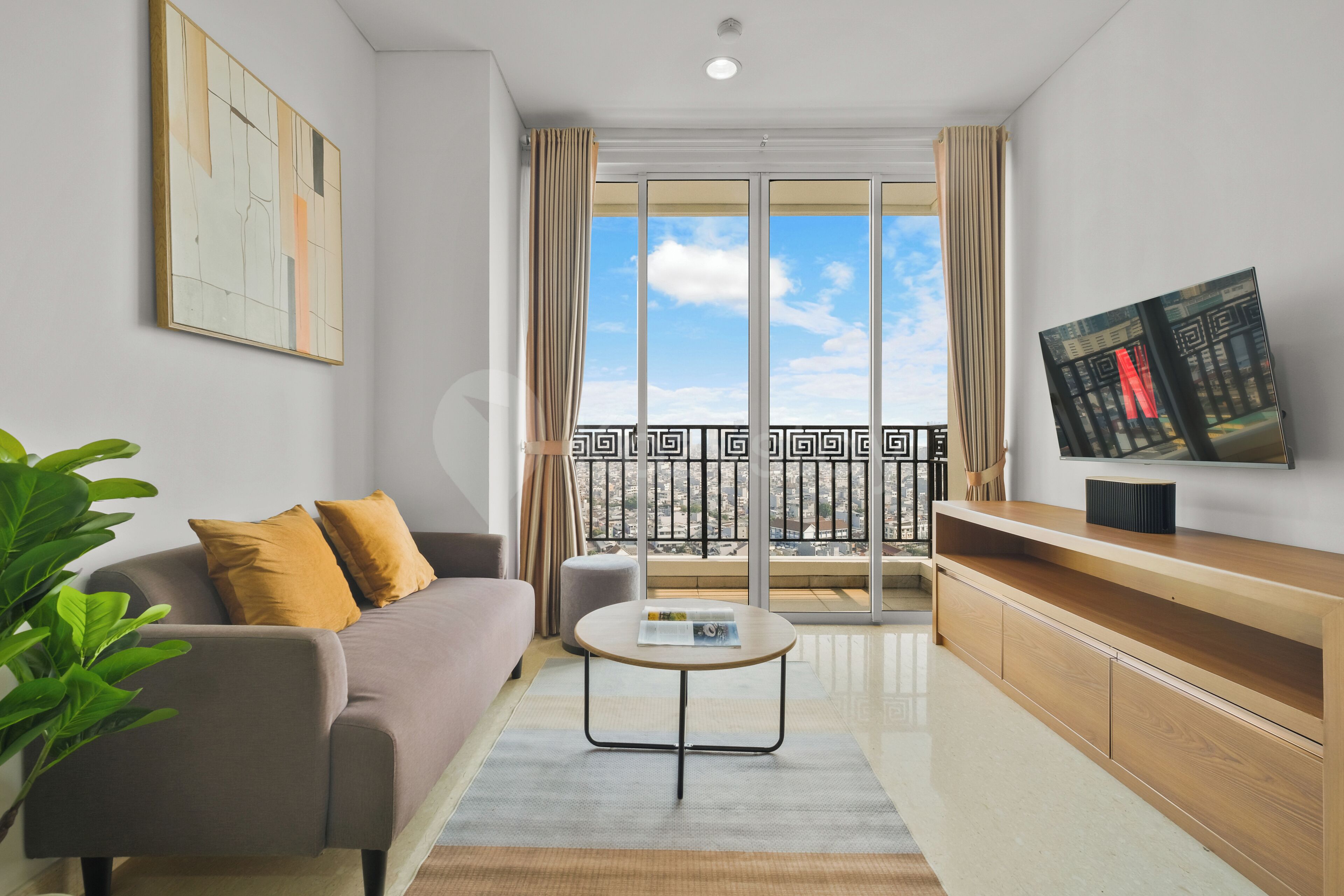 A modern living room with a sofa, coffee table, and a TV on a wooden stand.