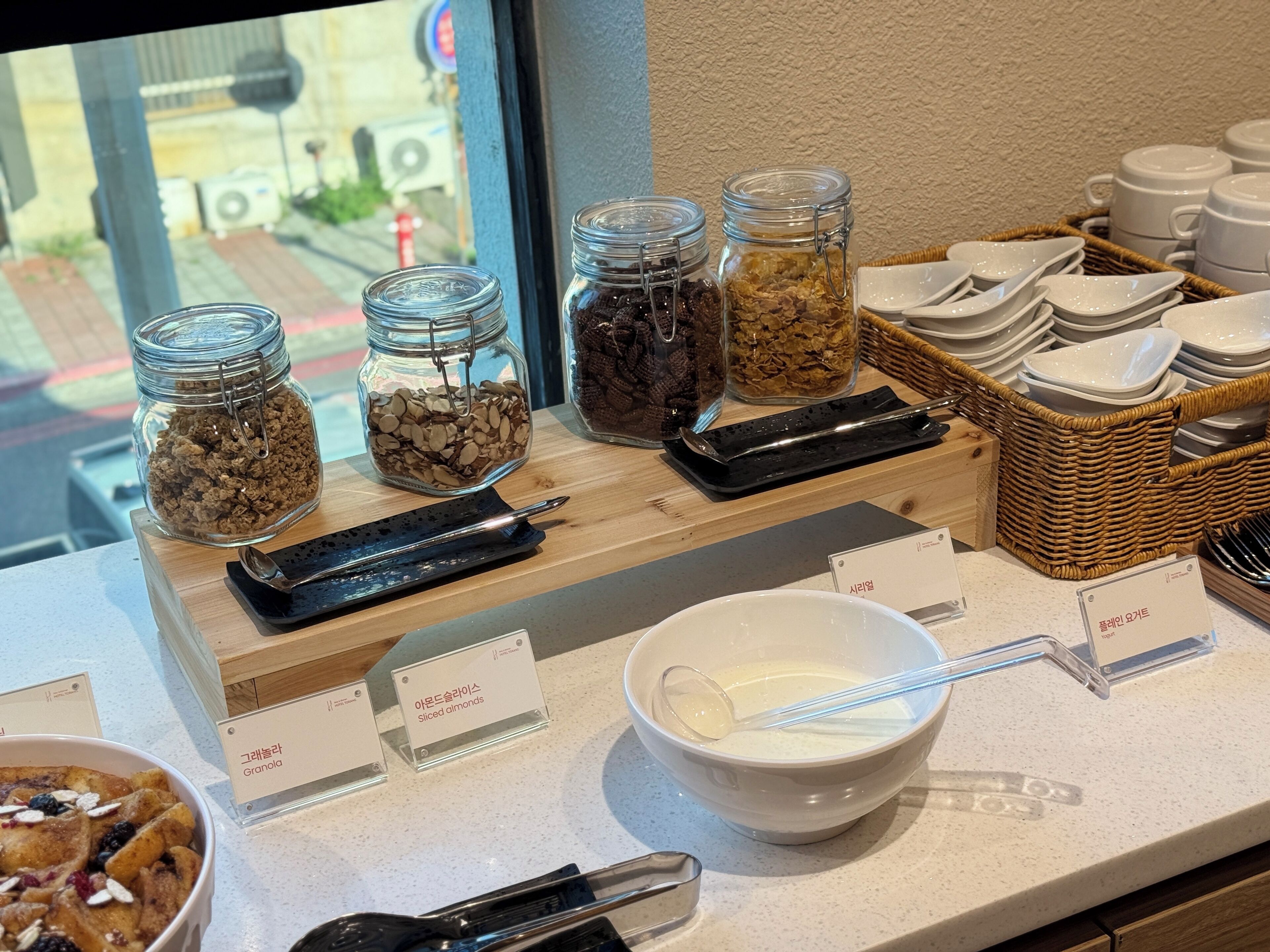 A breakfast buffet with various food items and utensils.