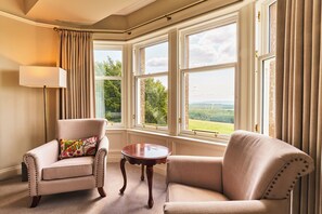 A room with a large window, a lamp, two armchairs, and a small table. - Kinclune House Luxury Estate Mansion, Angus Glens (Kirkton of Kingoldrum)