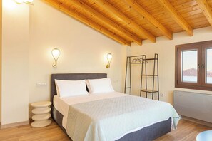 A bedroom with a bed, two wall-mounted light fixtures, a wooden ceiling, and a window with a view. - Studio Tepes - Velis Samos Sea View Balcony Suite (Kokkari)
