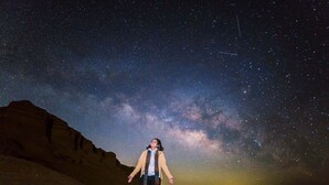 A person standing in a desert with a starry night sky. - 2-Day White Desert Safari Adventure ,Camping, Crystal Mountain & Stargazing (FraFra)