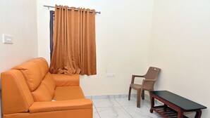 A living room with a sofa, a chair, and a small table. - HOTEL SIDDVEER GRAND (Guntur)