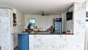A kitchen with a marble countertop, a refrigerator, and a freezer. - HOTEL SIDDVEER GRAND (Guntur)