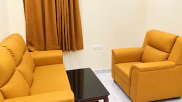 A room with two sofas and a small table.