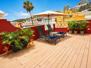 A rooftop terrace with two lounge chairs, a small table, and potted plants. - COLIVING CON COWORKING LIMPIEZA Y CAFÉ (Las Palmas de Gran Canaria)