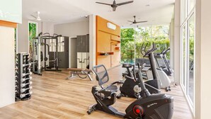A gym with exercise equipment, a weight rack, and a bench. - Kamala Jungle Suite 80m² Balcony, 2 Pools, Gym & Sauna Fast Fiber WiFi (Kamala, Kathu)