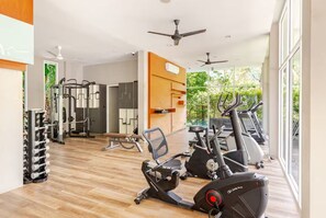 A gym with exercise equipment, a weight rack, and a bench. - Kamala Jungle Suite 80m² Balcony, 2 Pools, Gym & Sauna Fast Fiber WiFi (Kamala, Kathu)