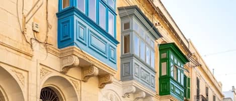 A street with buildings featuring classic architecture and colorful facades.