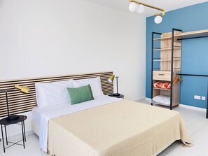 A neatly arranged bedroom with a bed, bedside tables, a lamp, and a built-in wardrobe. - Blu Mar Sea View Appartment 4 (San Pawl il-Baħar)