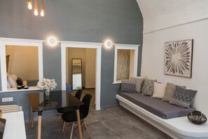 A modern interior with a dining area, a sofa, and a wall-mounted artwork. - Villa LuxL Family House (Mesaria)