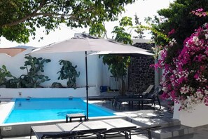 A swimming pool with lounge chairs and a covered area. - Villa LuxL Distillery Studio (Mesaria)