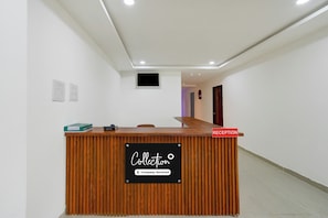 A reception desk with a sign indicating it is a company-serviced collection point.