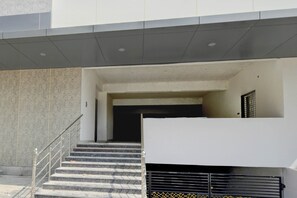 A building entrance with a staircase leading to a covered area. - Super Collection O Pragathi Nagar (Nizamabad)
