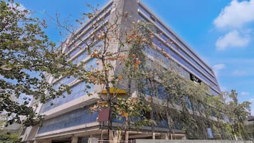 A modern building with a glass facade and a visible entrance.