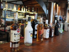 A bar with various bottles of alcohol on display. - Top Of The Loop Hostel Ha Giang (Ha Giang 1)