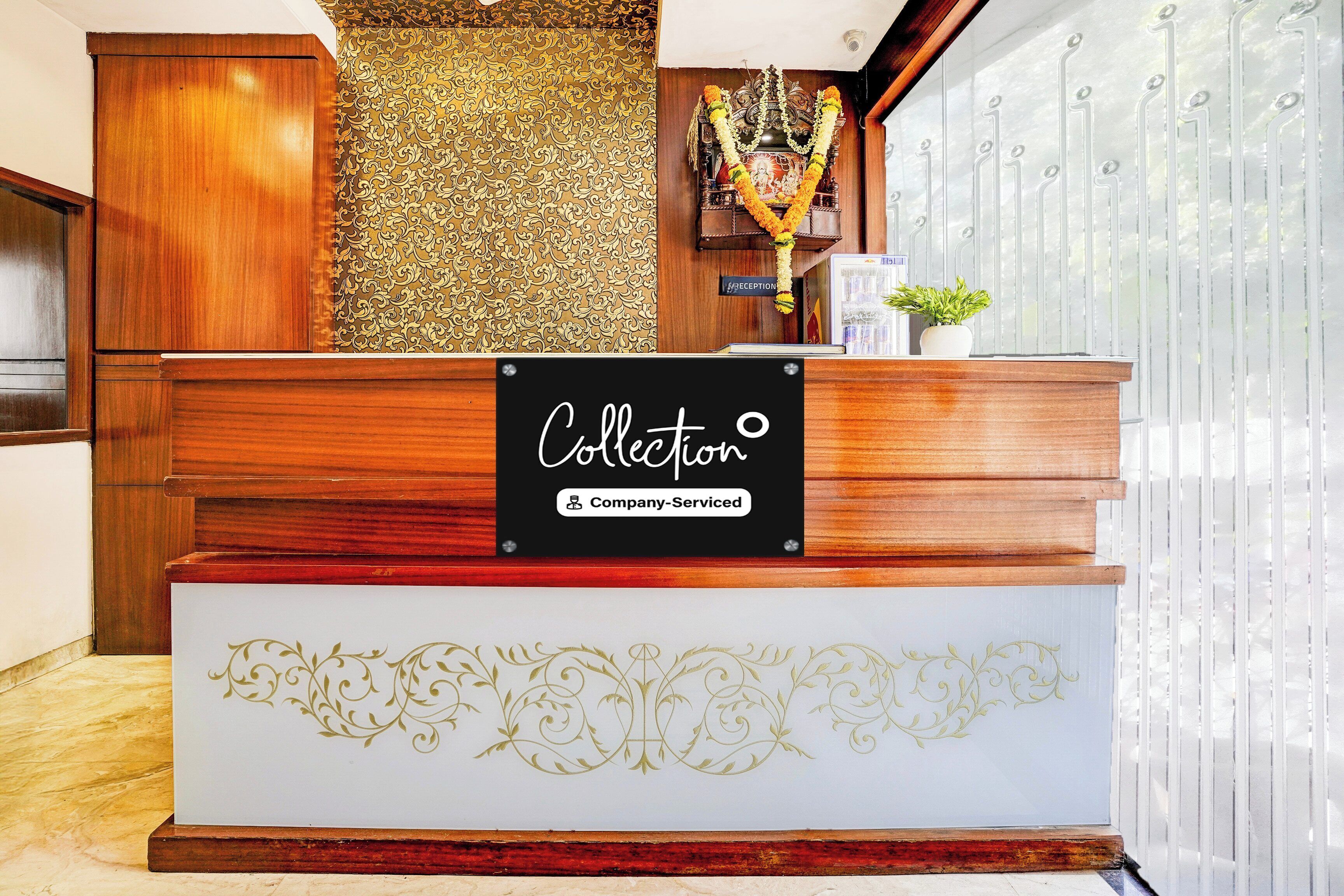A reception desk with a sign reading 'Collection' and 'Company Serviced'.