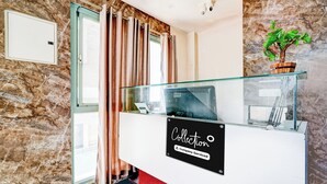 A reception desk with a sign that reads 'Collection Company Serviced.' - Super Collection O Rajkumar Road (Mysore)