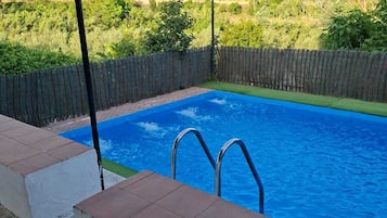 A swimming pool with a view of a mountainous landscape.