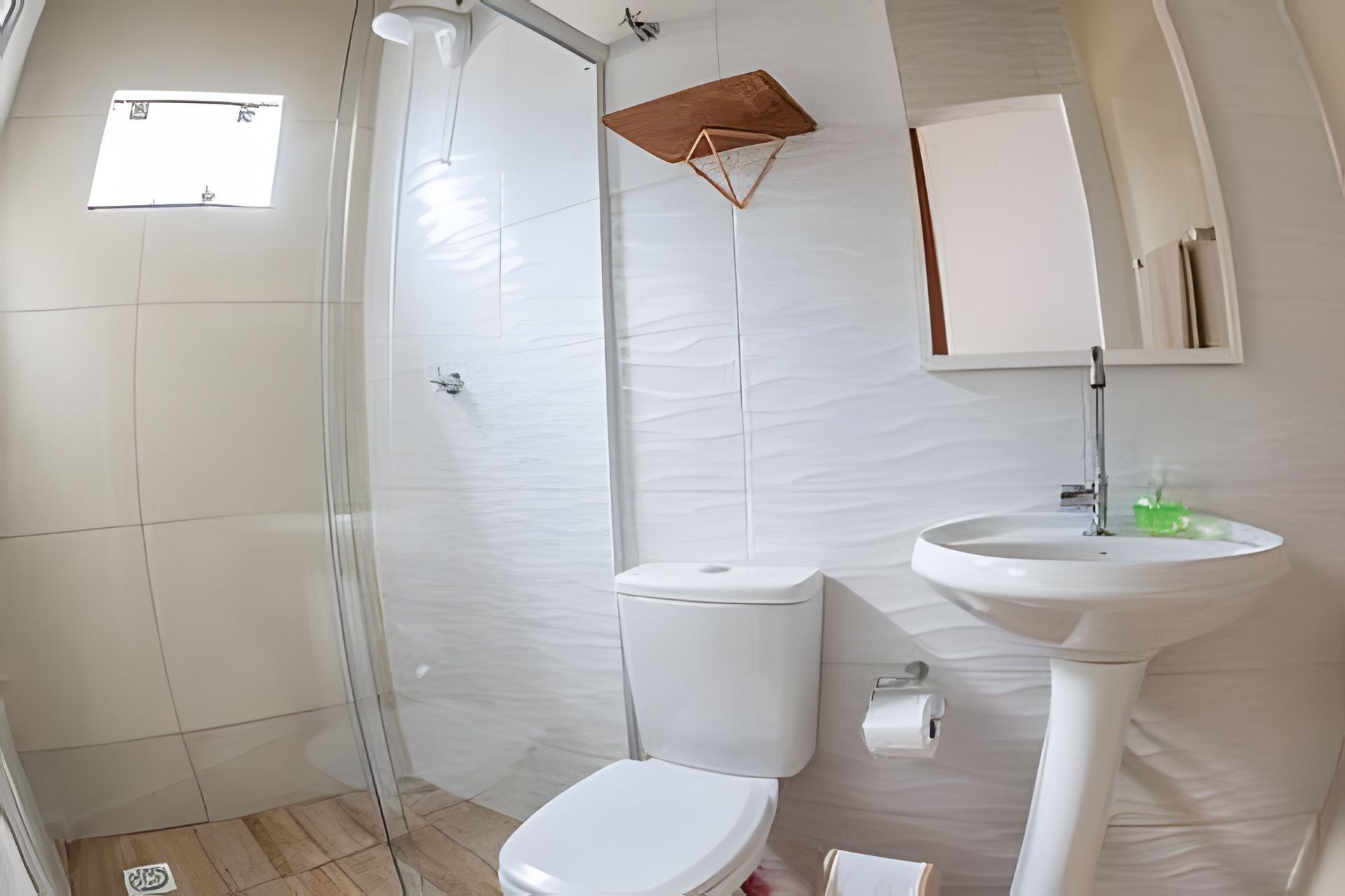 A bathroom with a toilet, sink, and shower.