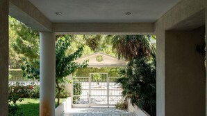 A covered entrance with a tiled floor leading to a gated area. - Luxe Bliss – 2BR, Glyfada (Glifada)