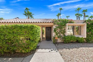 A house with a tiled roof, a front door, and a small window. - *Home - 570 N Lujo Cir, Palm Springs (Palm Springs)