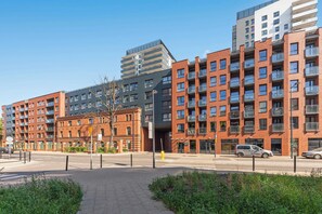 A multi-story residential building with balconies, a pedestrian walkway, and a clear sky. - Bastion Wałowa 49 | City Center | Parking (Gdańsk)