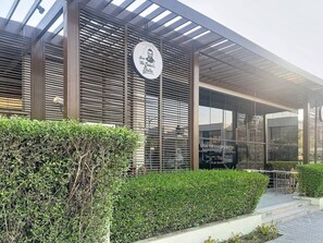 A modern building with a sign that reads 'Sven the Baker's Bistro' and a glass entrance.