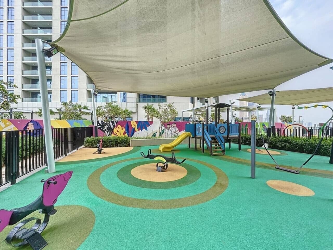 A children's play area with a slide, swings, and a climbing structure.