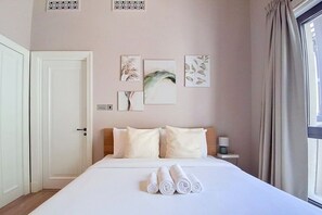 A hotel room with a bed, a nightstand, a window with curtains, and wall art. - Central 1 Bed l Minutes Walk to Dubai Mall (Downtown)